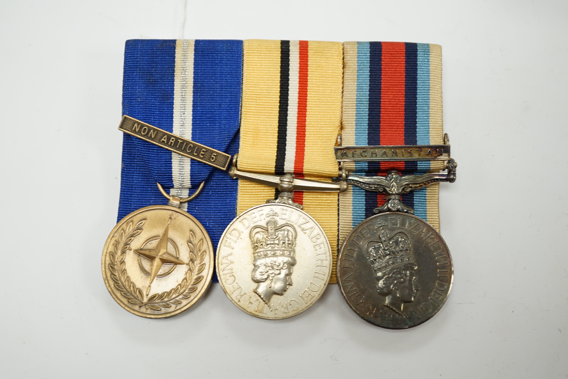 A Queen Elizabeth II medal group awarded to Signaller R.V. Johnson, Royal Signals, comprising; an Iraq Medal, an Operational Service Medal with a bar for Afghanistan and a UN Medal with a bar for Non Article 5, mounted t